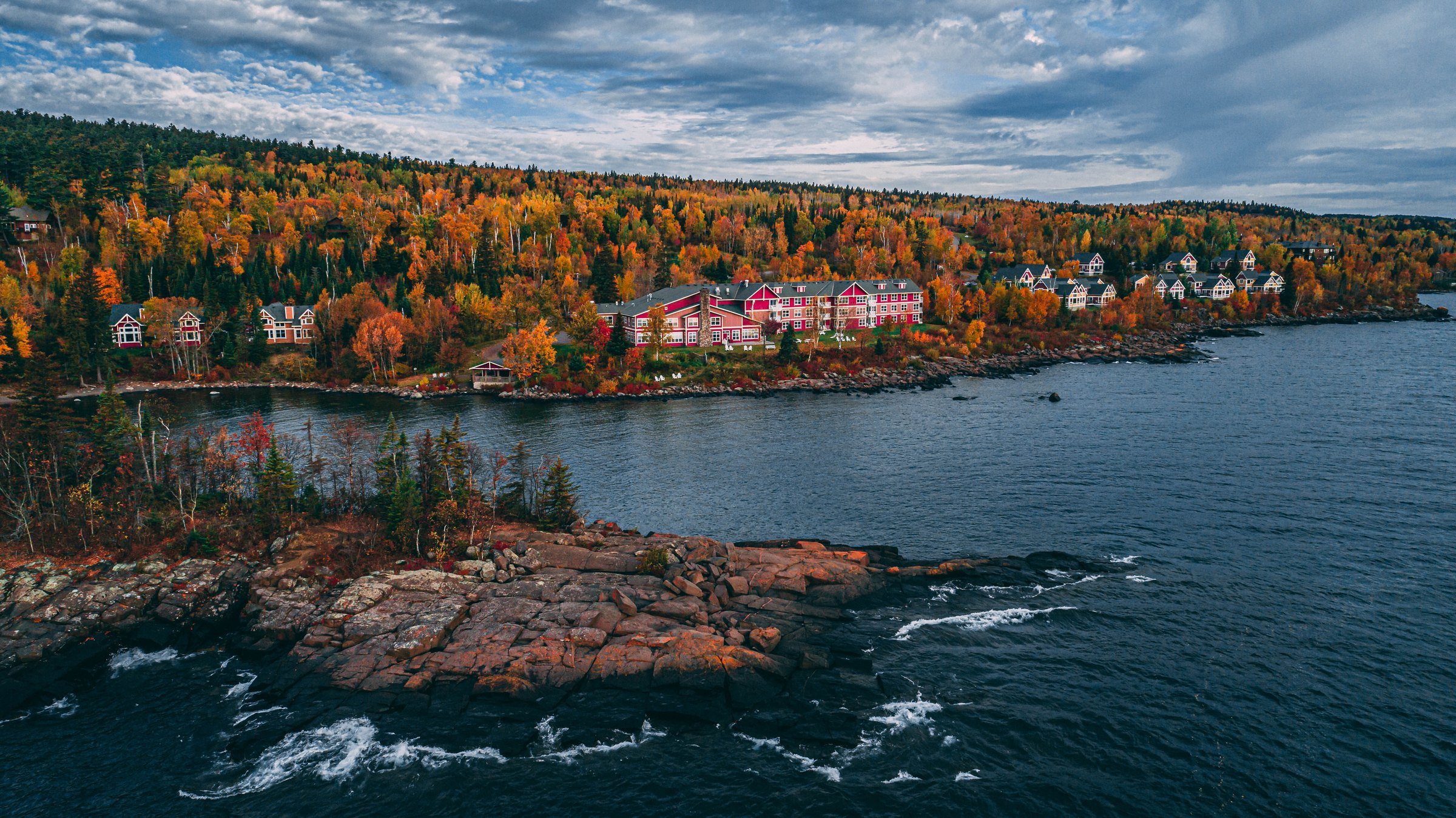 Aerial view of Cove Point Lodge on Lake Superior in Beaver Bay, Minnesota, surrounded by fall colors