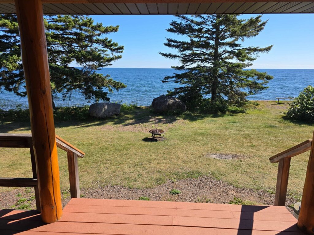 View of Lake Superior from a covered cabin deck at Ours Resort