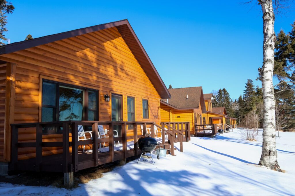 Row of log cabins in the snow at Ours Resort in Lutsen, Minnesota