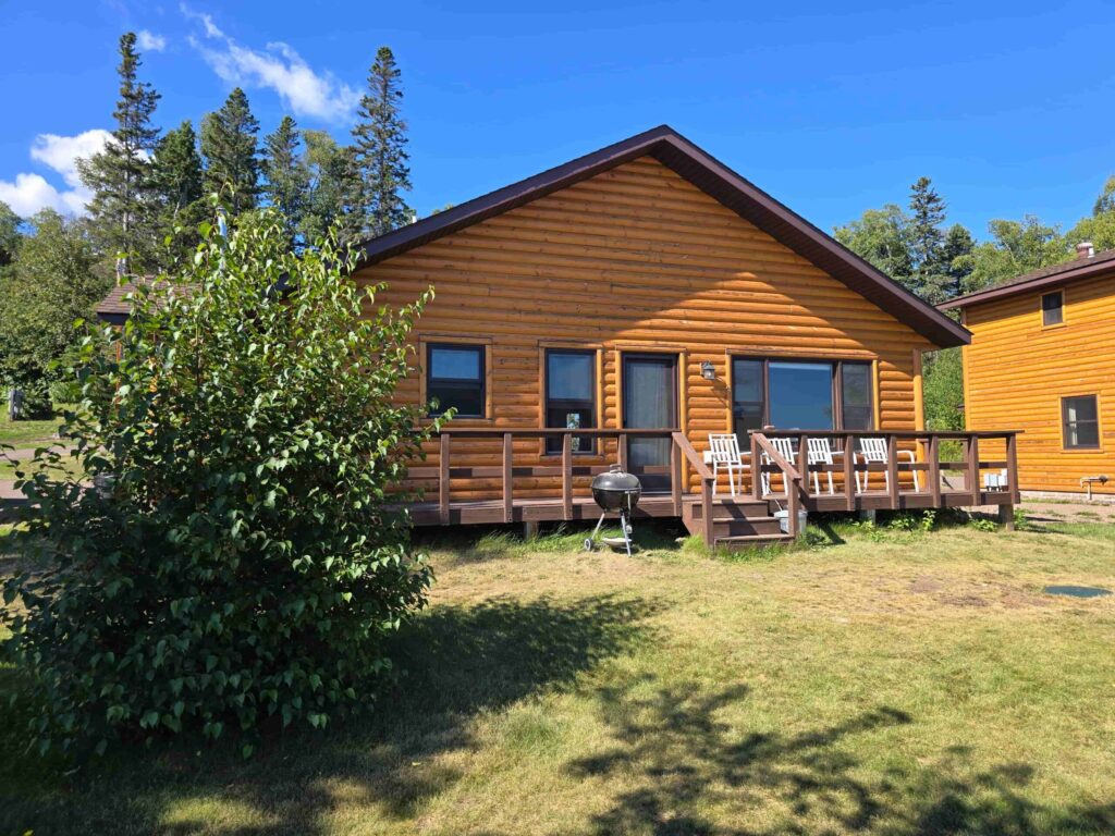 Two log cabins with decks and grills at Ours Resort in Lutsen